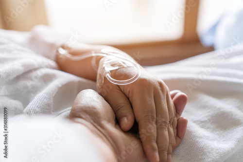 Loving couple holding hands, Hopeful, care love emotional concept, Together Couple women hold hand lover while Sick Patients saline. Encouragement comforting Recovering from family healthy moment