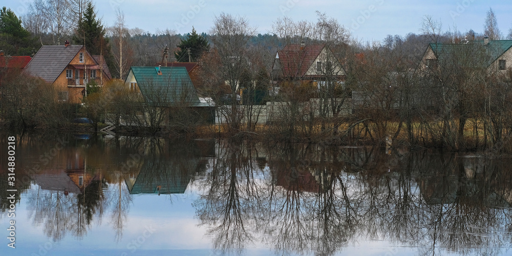 Fototapeta premium country houses on a bank of Volhov river in Volhov, Russia