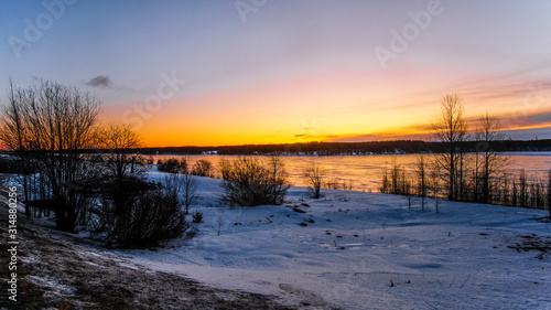 Landscape with the image of the ice covered frozen river Kem in Karelia, Russia