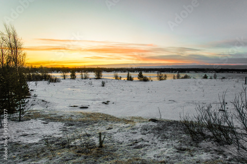 Landscape with the image of the ice covered frozen river Kem in Karelia, Russia