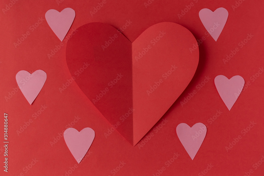 Red paper heart on a red background. Valentine's Day. Valentine's Day. Love and heart..