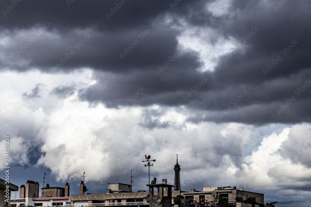 Paris skyline with Eiffel tower in the background under the dramatic sky with clouds Paris skyline with Eiffel tower in the background under the dramatic sky with clouds