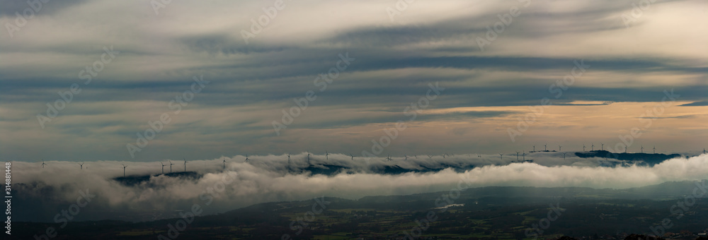 Mountainous landscape with clouds and fog, panoramic image