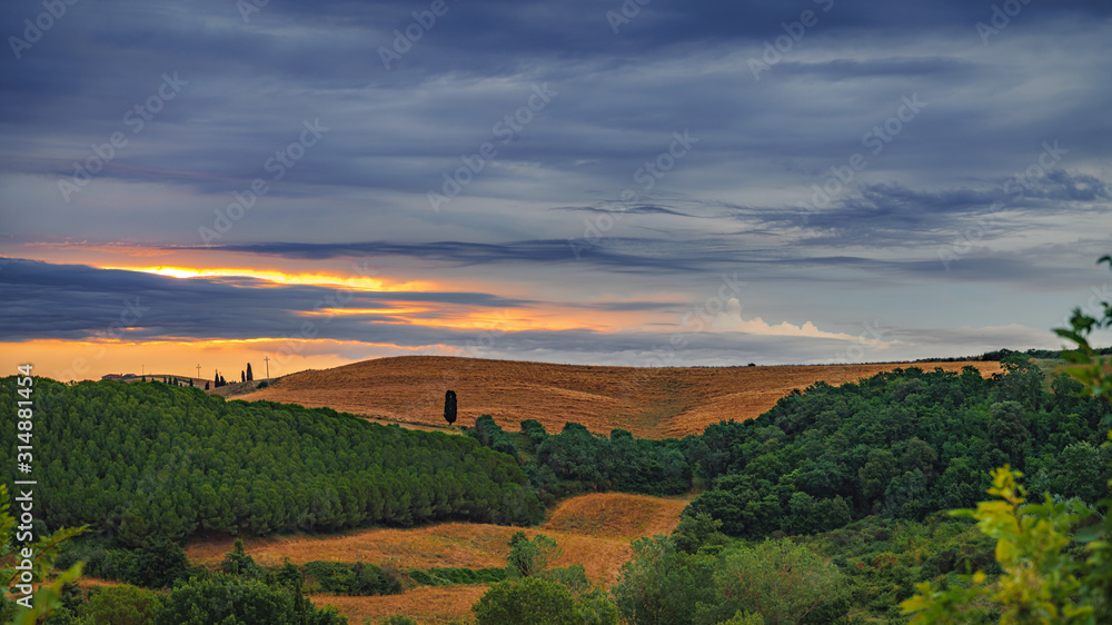 Colorful dark sunset over the field.  Travel destination Tuscany