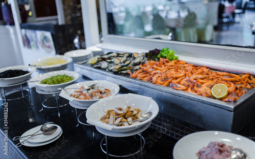 Fresh green mussel and shrimps in seafood on ice buffet bar