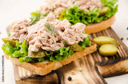 Wallpaper Mural Homemade tuna salad sandwiches on cutting board with pickles aside Torontodigital.ca