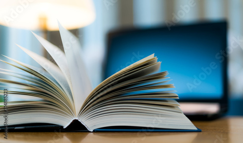 Open book lying on the table in the library