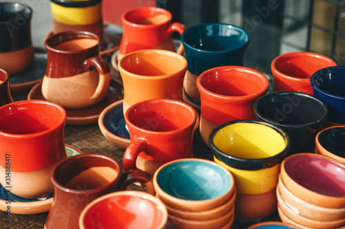 A lot of multi-colored pottery. Hand-made products