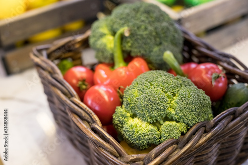 Fresh vegetables in basket on the table. red tomatoes, broccoli, potato, peppers,red paprika. Bio Healthy food, herbs and spices. Organic vegetables. Selective focus.