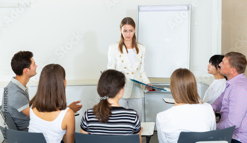 Female business coach communicating with auditorium