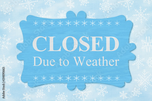 фотографія Closed Due to Weather message on a wood sign