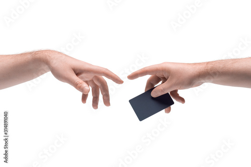 Two male hands passing one another a black plastic discount or credit card on white background