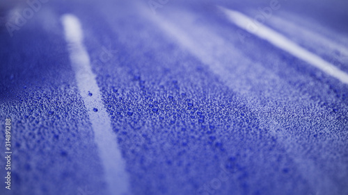 Closeup blue car paint surface with hydrophobic ceramic coating photo