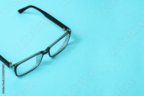 Glasses for reading, computer work and eye protection. Plastic glasses with a black frame. Optical device for vision correction