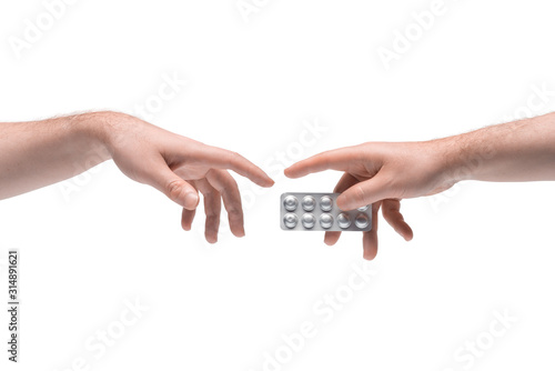 Two male hands passing one another pills package on white background (ID: 314891621)