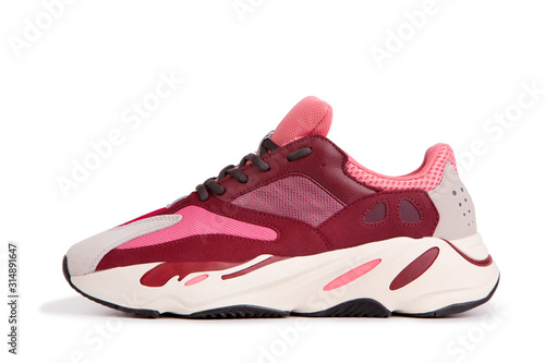 Colored sneakers close-up. Fashionable sneakers isolate on a white background. Modern trendy sneakers side view.