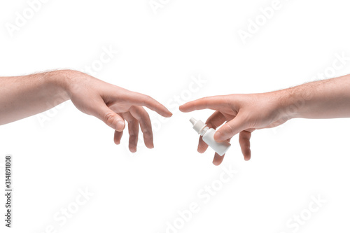 Two male hands passing one another white small plastic phial with nasal spray on white background