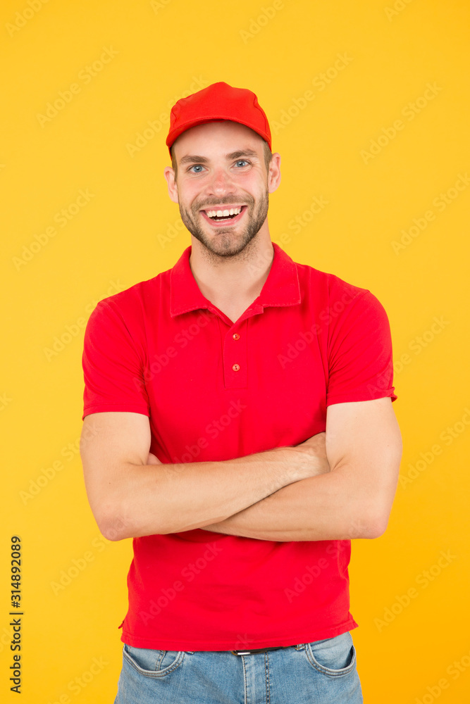 Courier and delivery service. Postman delivery worker. Man red cap yellow background. Delivering purchase. Already ready. Easing your business. Service delivery. Salesman and courier career