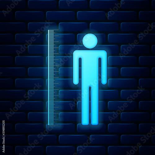 Glowing neon Measuring height body icon isolated on brick wall background. Vector Illustration