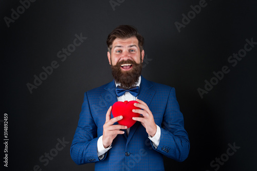 Wedding day. Bearded man groom in formal suit. Health care. Heart in hands. Best wishes from sincere heart. Businessman in bow tie. Heart symbol aesthetics. Valentines day holiday. Love and relations © be free