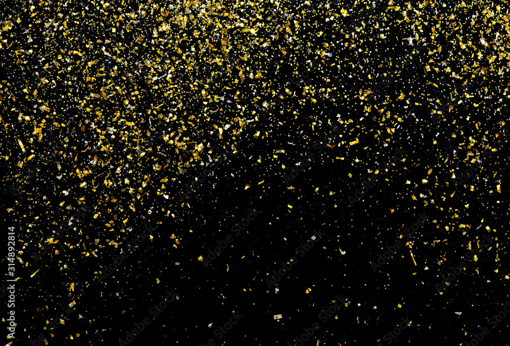 Golden glitter texture on black abstract background