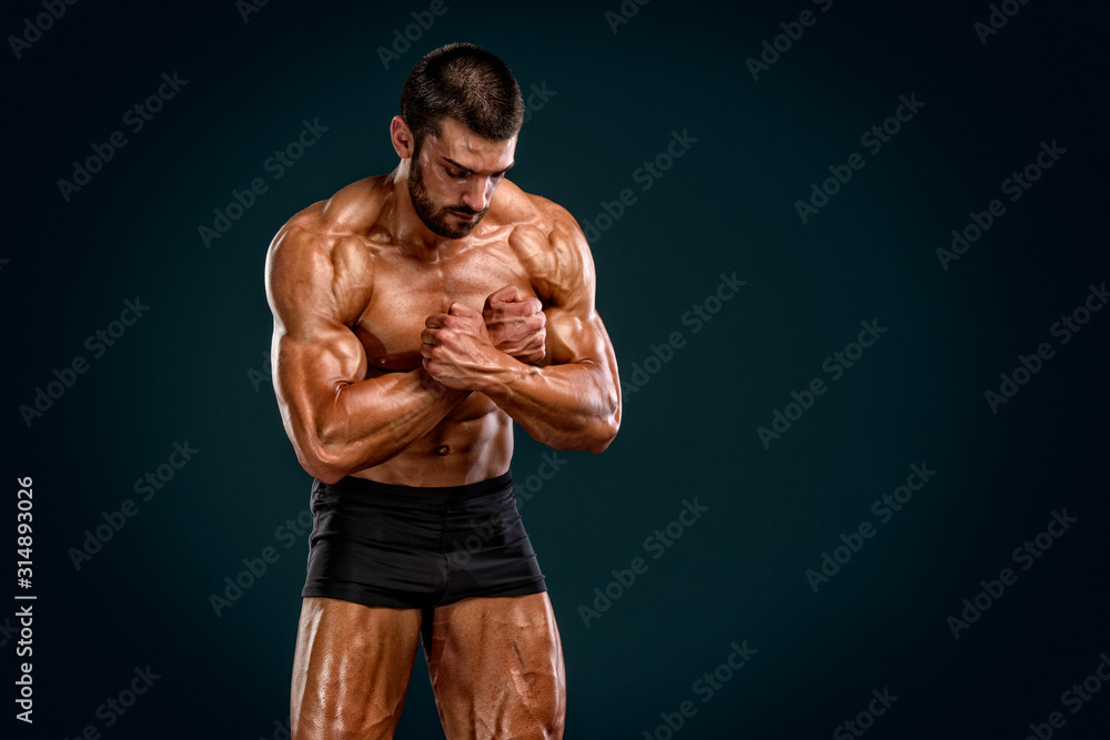 Bodybuilder Posing and Flexing Muscles. Studio Shot