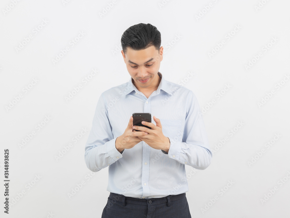 Young handsome asian business man playing smartphone with smiling isolated on white background. Young handsome asian business man playing smartphone with smiling isolated on white background.