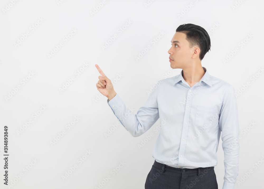 Young asian business man with blue shirt pointing to the side with a hand to present a product or an idea isolated on white background. Young asian business man with blue shirt pointing to the side with a hand to present a product or an idea isolated on white background.