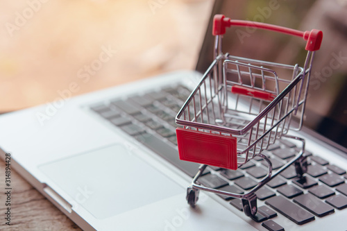Shopping online concept - Empty shopping cart or trolley on a laptop keyboard. Shopping service on The online web. offers home delivery..