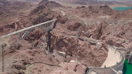 Aerial.Concrete arch-gravity dam located at the border of two states,known as Hoover Dam and the Memorial bridge over the Colorado river. The view into the canyon with the green water of the river