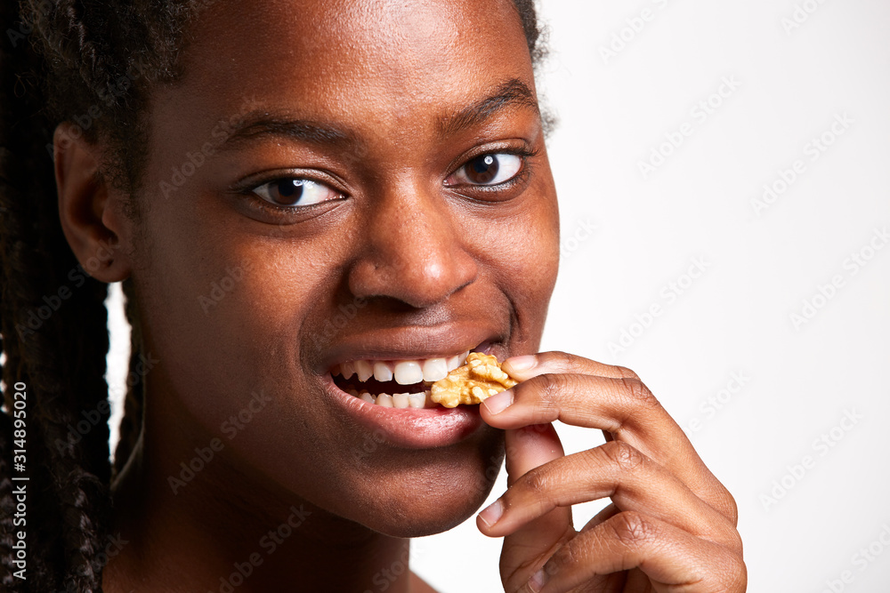 Studio portrait of a funny young African woman eating a salad. Fresh fruits and healthy diet concept. Studio portrait of a funny young African woman eating a salad. Fresh fruits and healthy diet concept.