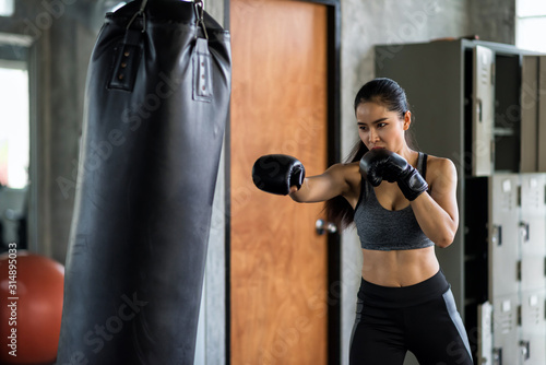woman boxing train by punching bag © Blanscape