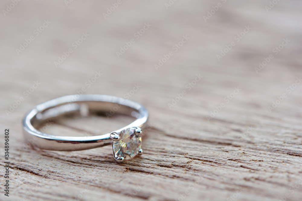 Diamond ring, wedding ring on plank wooden with copy space . Diamond ring, wedding ring on plank wooden with copy space .