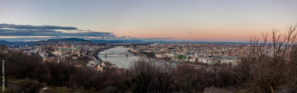 Fototapeta premium Aerial panoramic view Budapest, Hungary by sunset. Buda castle, Chain bridge and Parliament building