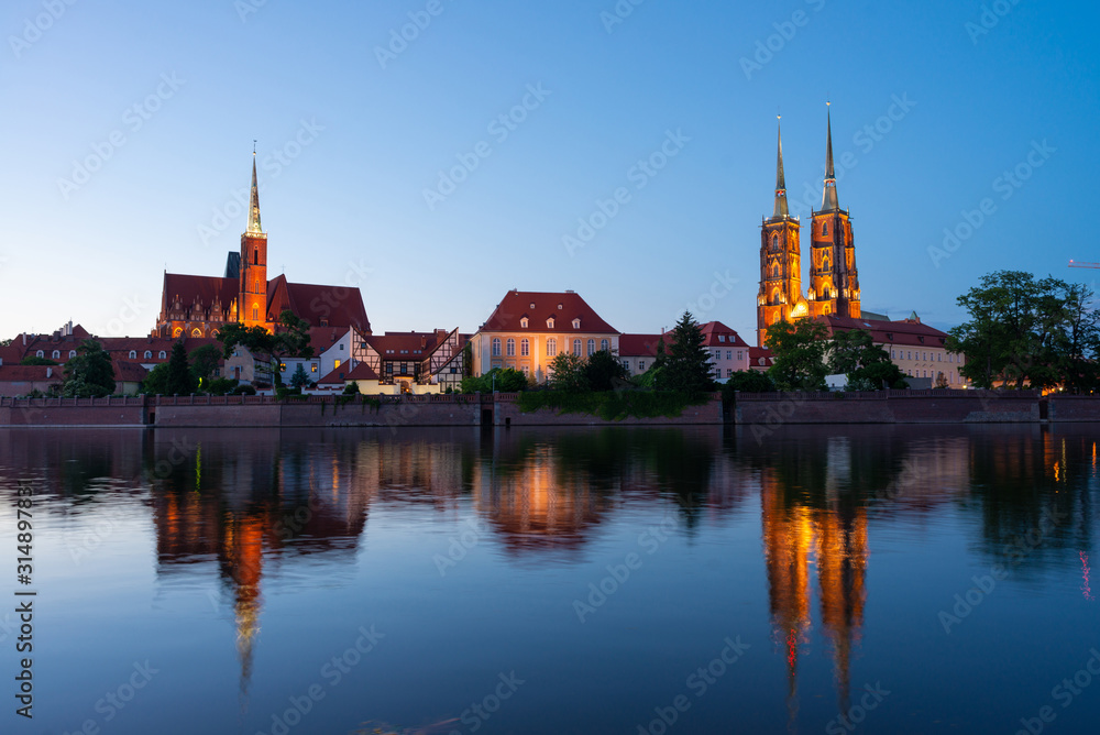 Sightseeing of Poland. Cityscape of Wroclaw, beautiful night view. The view at Tumski island and Cathedral of St John the Baptist, Church of Our lady on the Sand, Odra river.