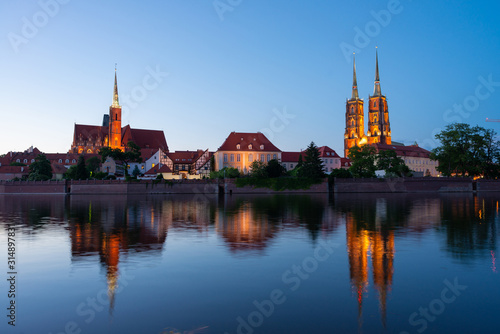Sightseeing of Poland. Cityscape of Wroclaw, beautiful night view. The view at Tumski island and Cathedral of St John the Baptist, Church of Our lady on the Sand, Odra river.