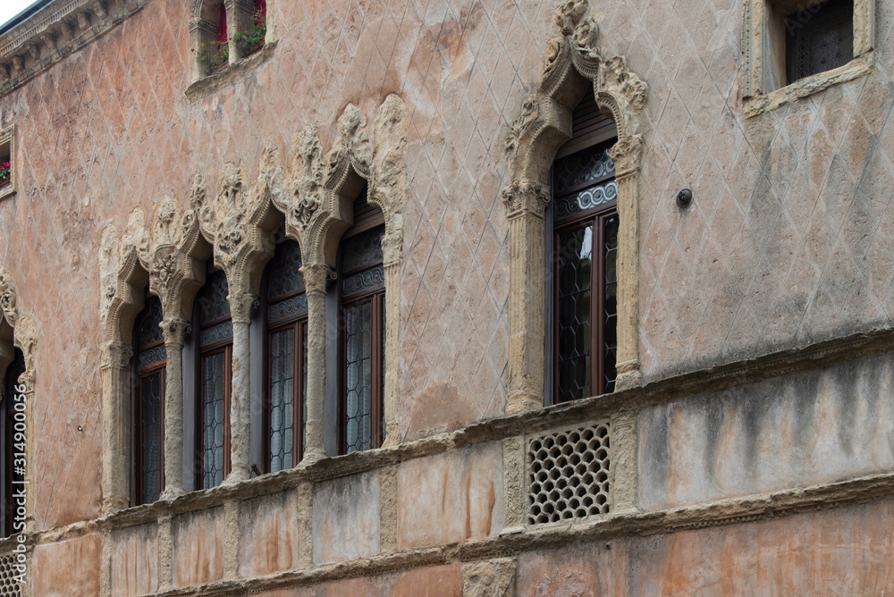 Old mullioned windows in Venetian style tuff in Padua, Italy.