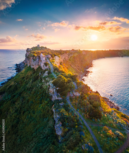 View from flying drone. Aerial spring view of Milazzo lighthouse. Gorgeous morning scene of Milazzo peninsula. Stunning sunrise on Sicily, Italy, Europe. Beauty of nature concept background. photo