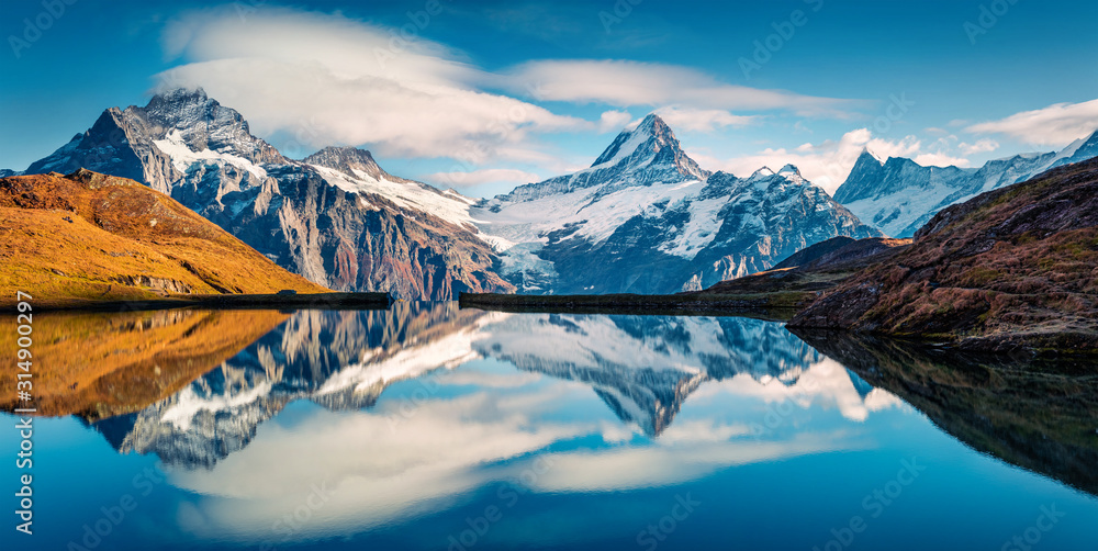 Panoramic morning view of Bachalp lake / Bachalpsee, Switzerland. Majestic autumn scene of Swiss alps, Grindelwald, Bernese Oberland, Europe. Beauty of nature concept background.