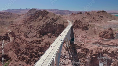 Nevada, Arizona, USA. The view of the bridge over the Colorado river near the wellknown Hoover dam. The canyon under the bridge and the rocks around. Cars move over the bridge road. Aerial survey.