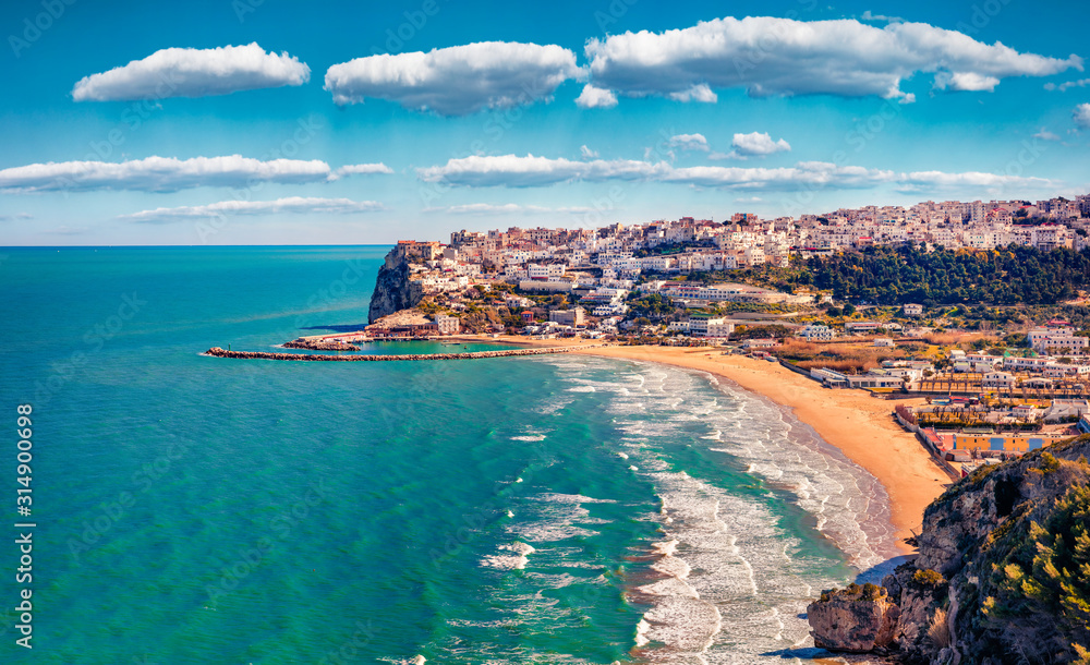 Splendid spring cityscape of Peschici town, Province of Foggia, Italy, Europe. Magnificent morning seascape of Adriatic sea. Top down view. Traveling concept background.