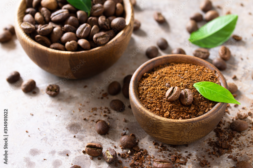 Coffee background. Coffee beans and ground powder on a stone concrete tabletop. Copy space. Coffee background. Coffee beans and ground powder on a stone concrete tabletop. Copy space.
