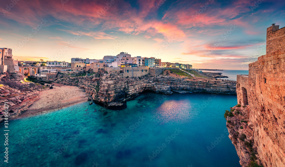 Unbelievable spring cityscape of Polignano a Mare town, Puglia region, Italy, Europe. Marvelous evening seascape of Adriatic sea. Traveling concept background.
