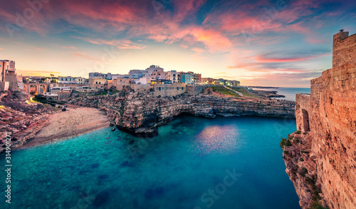 Fototapeta Naklejka Na Ścianę i Meble -  Unbelievable spring cityscape of Polignano a Mare town, Puglia region, Italy, Europe. Marvelous evening seascape of Adriatic sea. Traveling concept background.