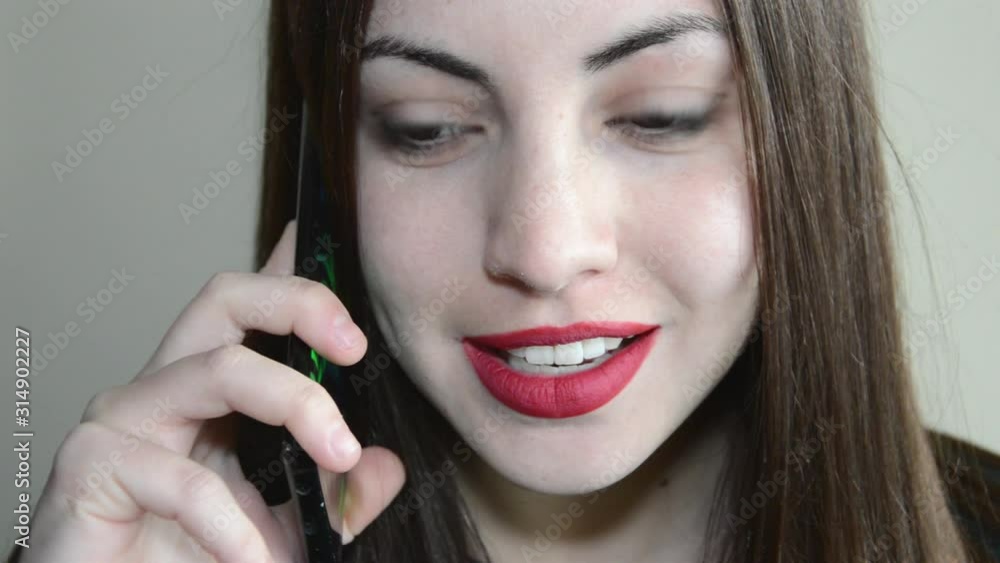 Attractive young woman talking on a mobile phone Attractive young woman talking on a mobile phone