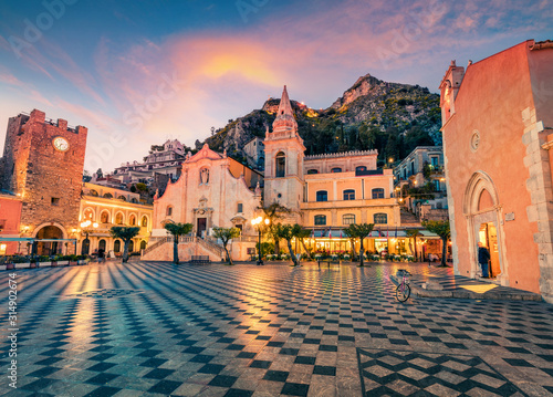  Fantastic evening view of Taormina town, IX Aprile plaza with San Giuseppe church and old fortress on background, Sicily, Italy, Europe. Traveling concept background.