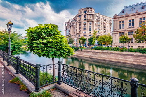Beautiful morning cityscape of Bucharest city - capital of Romania, Europe. Splendid  summer view of Dambovita River. Traveling concept background. photo