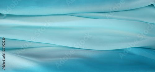 Blue color silk fabric texture abstract background.