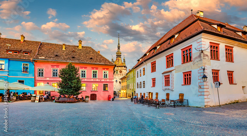 Picturesque evening view of famous medieval fortified city and the Clock Tower built by Saxons. Splendid  summer cityscape of Sighisoara, Transylvania, Romania, Europe. Traveling concept background.