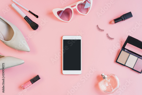 woman cosmetics and fashion items with smartphone and copy space, Top view